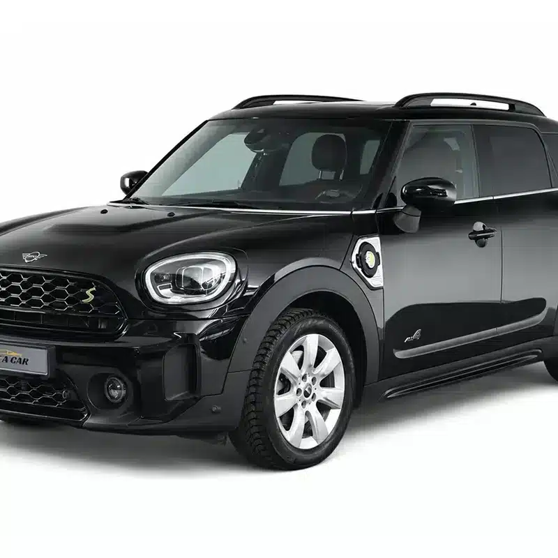 Black Mini Countryman SUV parked, promotional rental car with “Rent A Car” plate visible on the front bumper.